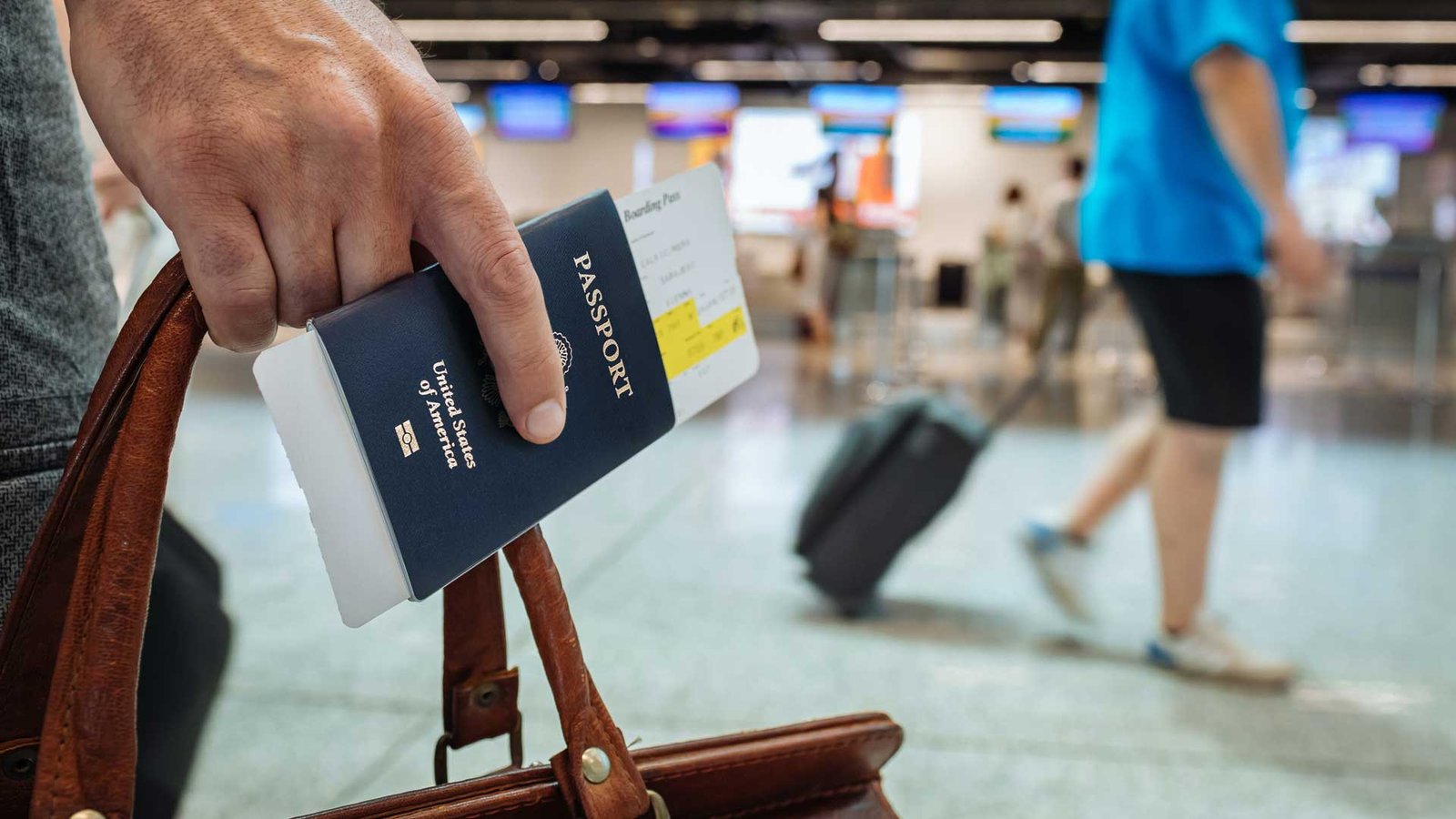 Student holding a passport and boarding pass at the airport